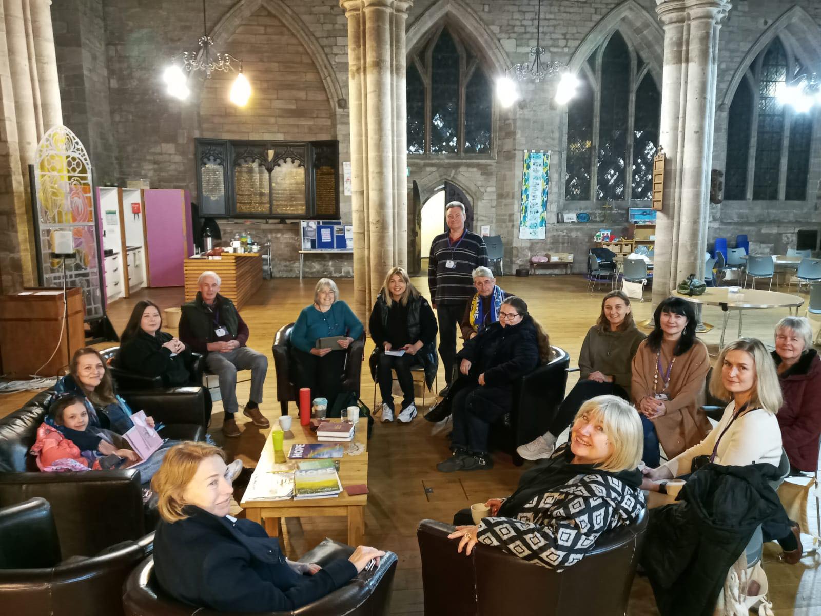 A group of people sitting in a circle in a church setting