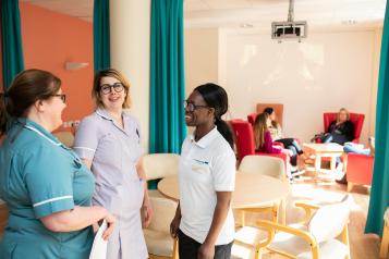 A group of health professionals talking to one another