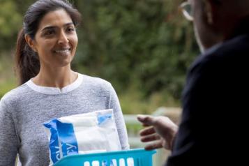 Lady delivering a prescription to someone at home