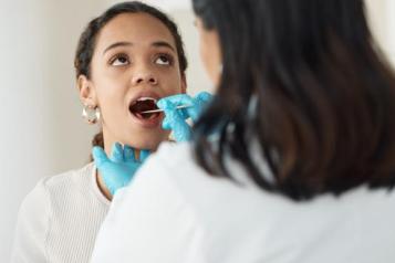 Young girl getting her teeth checked by a dentist