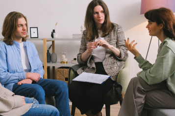 Group of people sitting down and talking and listening