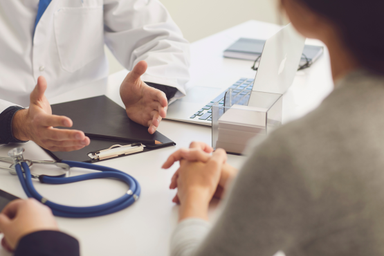 Photo of a doctor and patient hands in a surgery