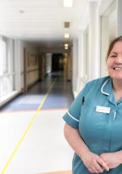 A nurse standing in a hallway in a hospital